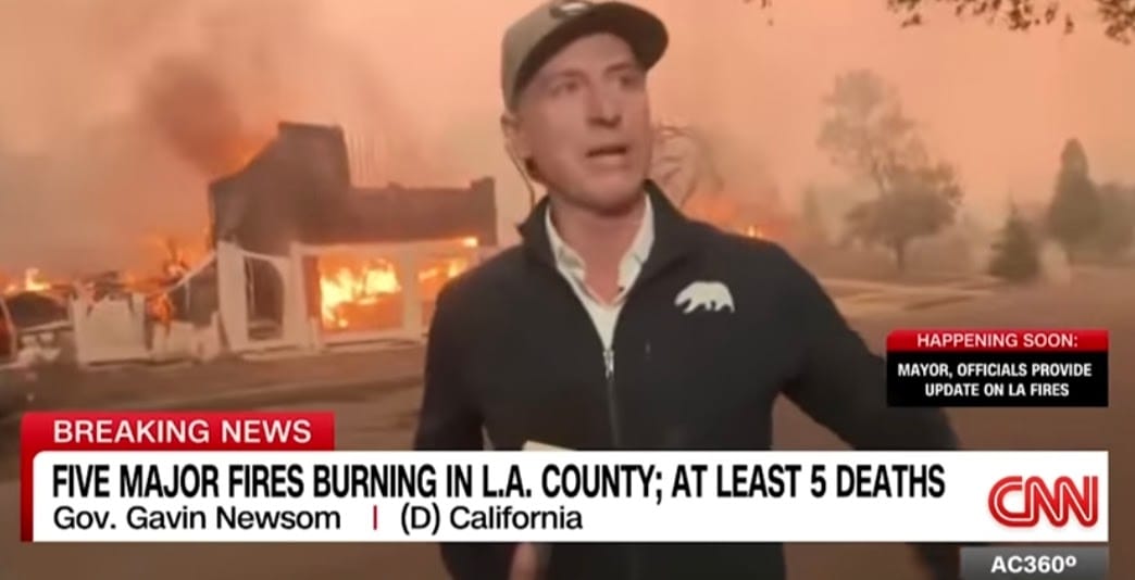 Interview with Governor Newsom; as he casually stands behind a burning house.